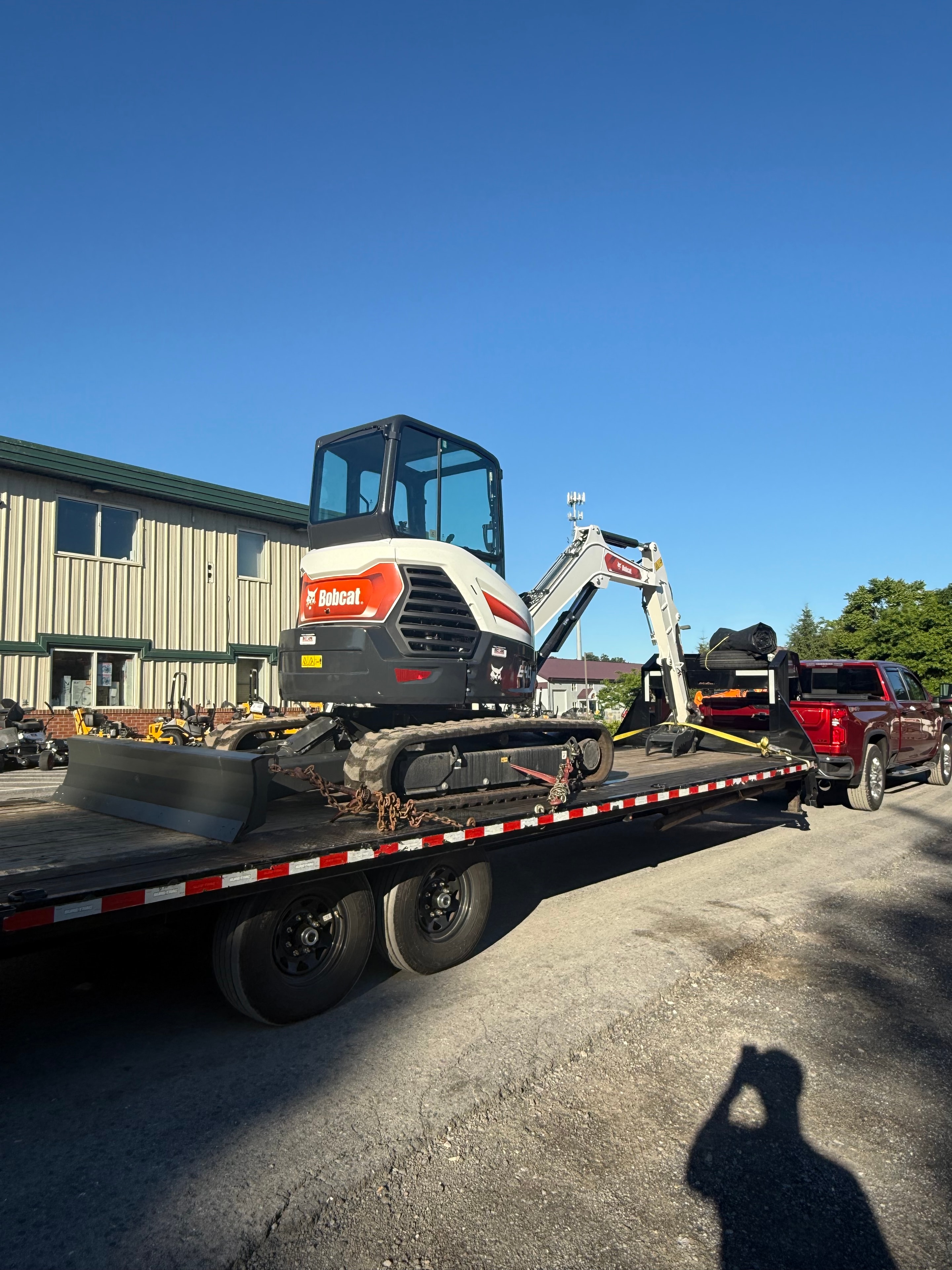 Bobcat excavator loaded on flatbed trailer