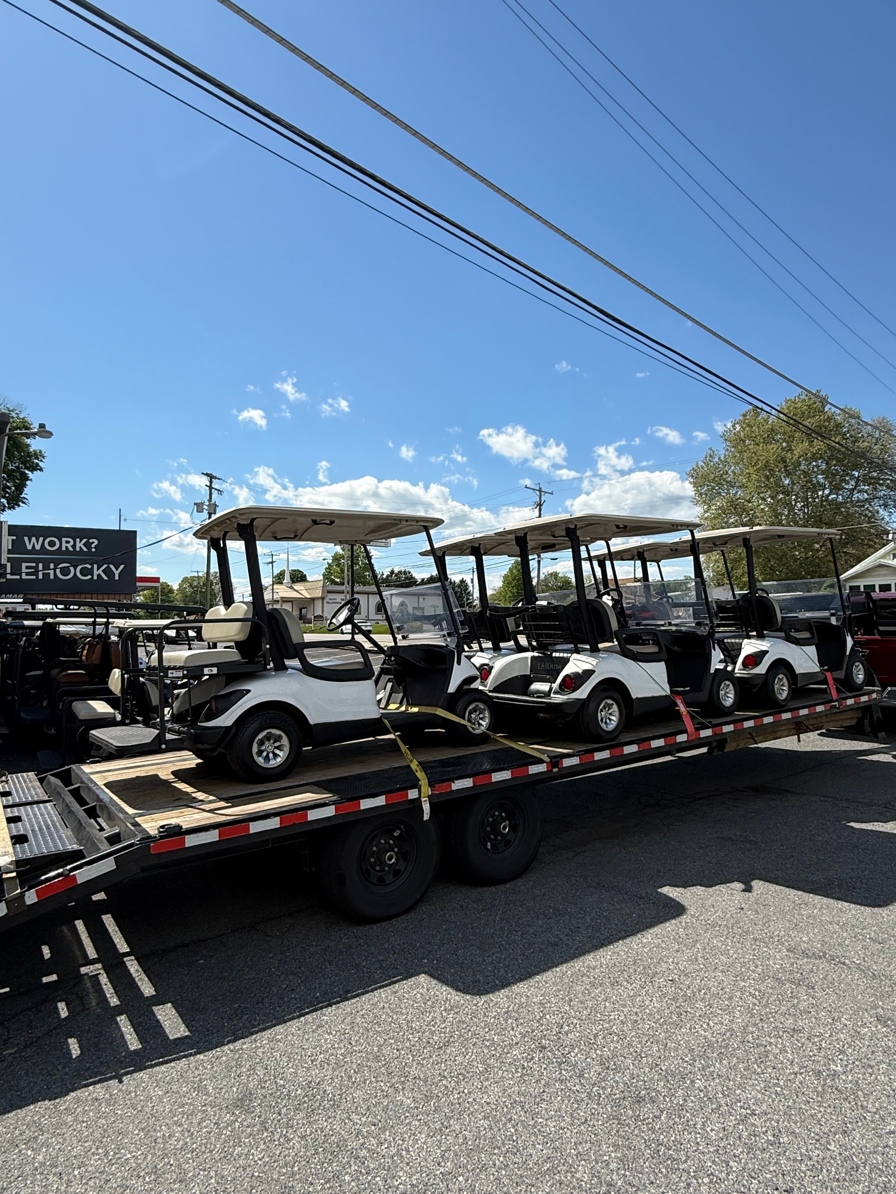 Golf carts and utility vehicles on flatbed trailer